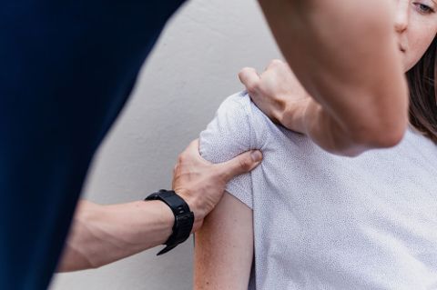Therapist assessing a patient's shoulder mobility